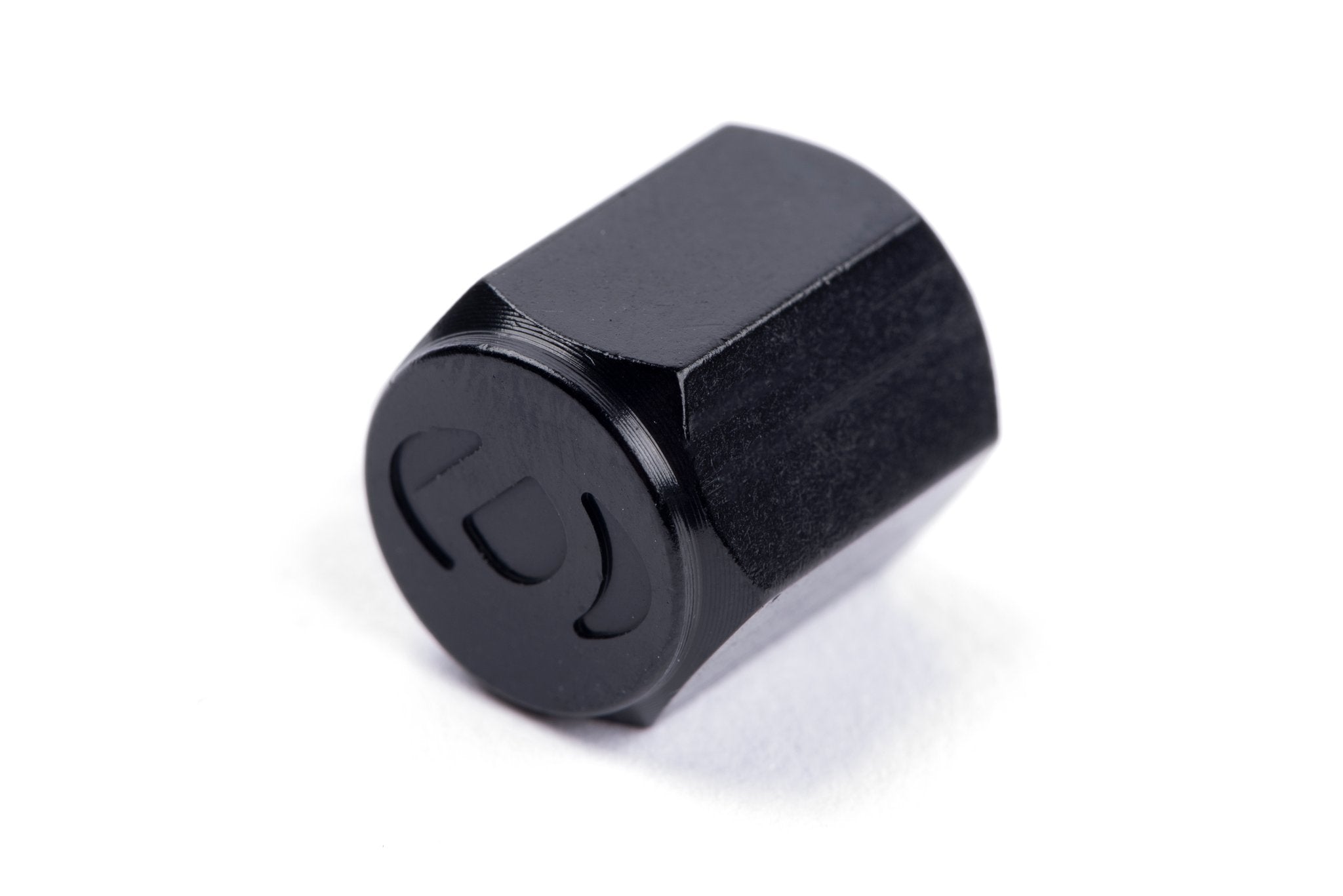Dinan Valve Stem Caps - Photo - out of package Left
